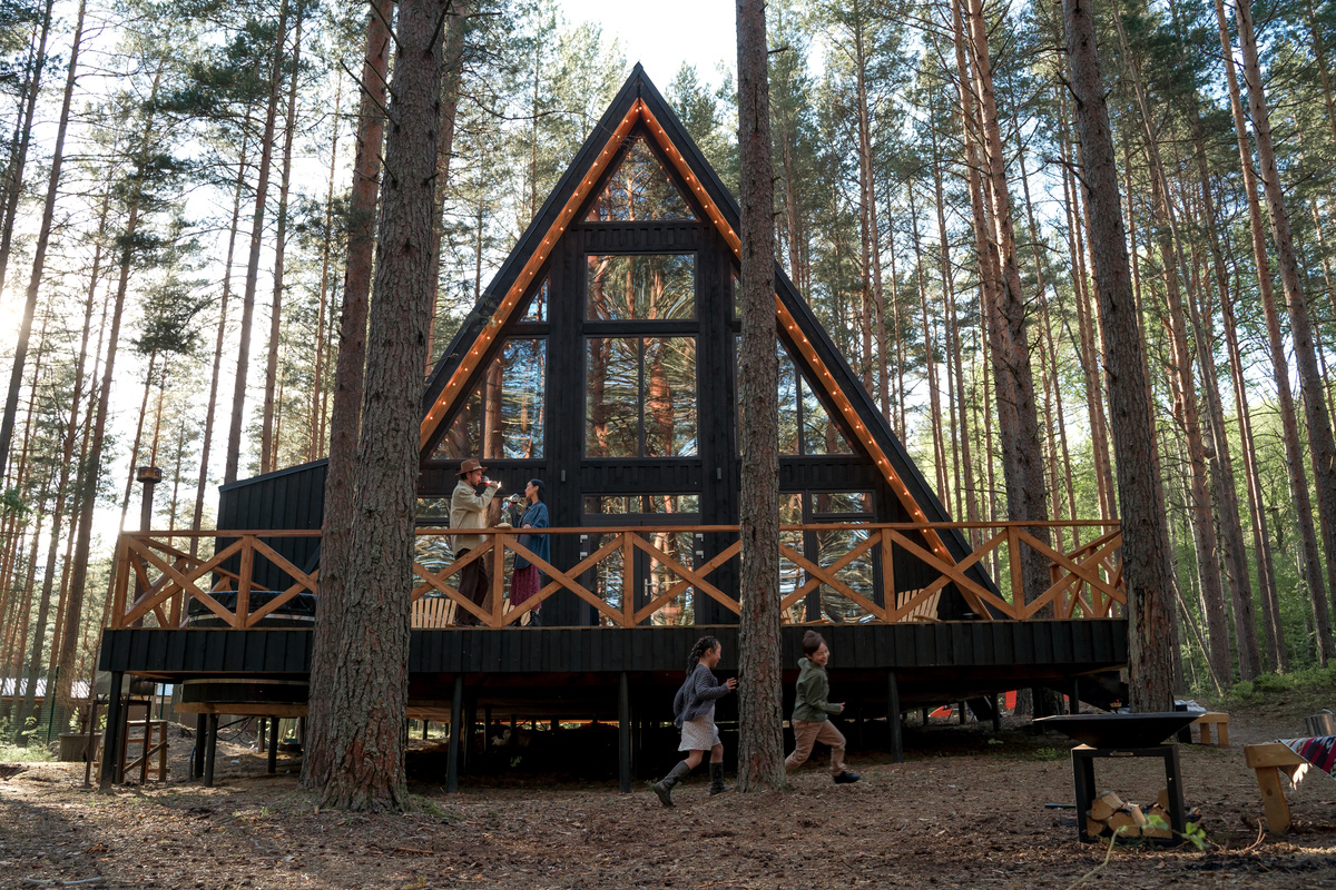 an a frame cabin in the middle of the woods